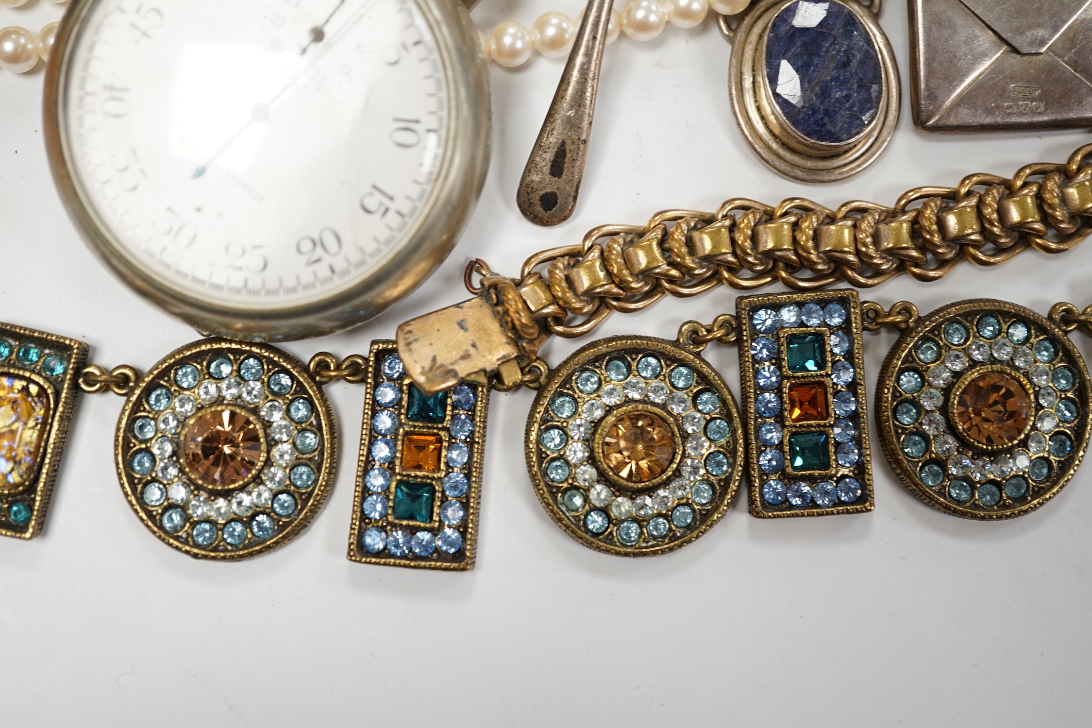 A small group of assorted costume jewellery, wrist and pocket watches and a silver envelope stamp case.